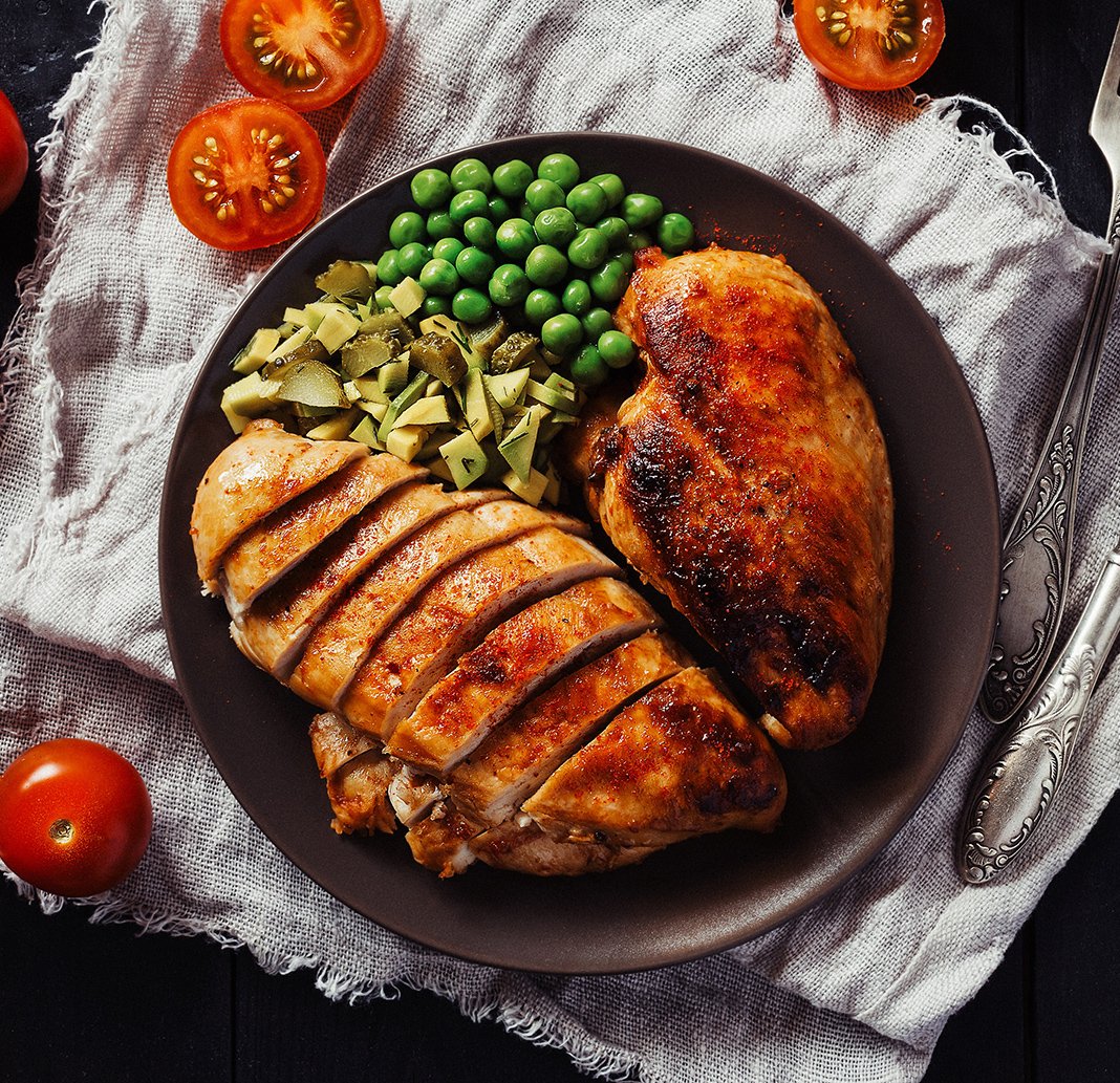 Grilled chicken breast served with a side of vegetables